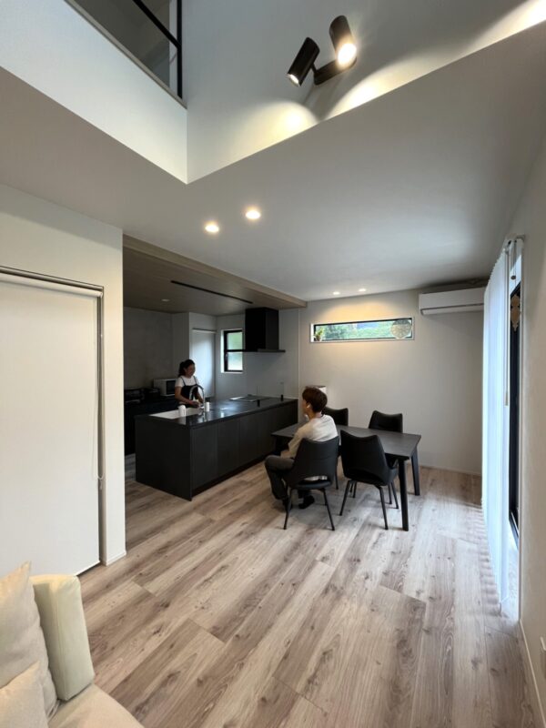 「人情味にあふれていましたので、井上建設を選びました!」お客様の声紹介ページ。ダイニングで談笑するご夫婦の画像